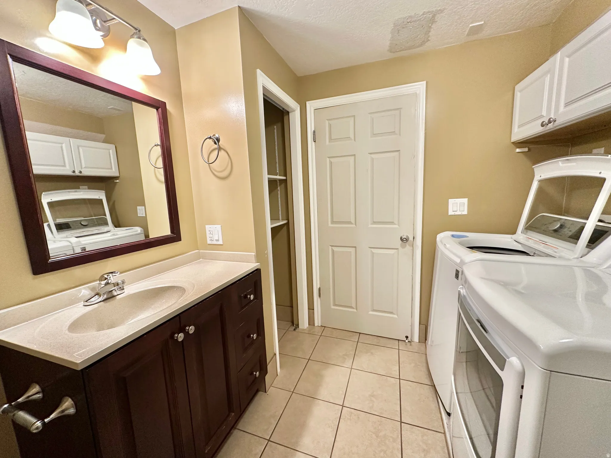 Laundry room and bathroom shared space.