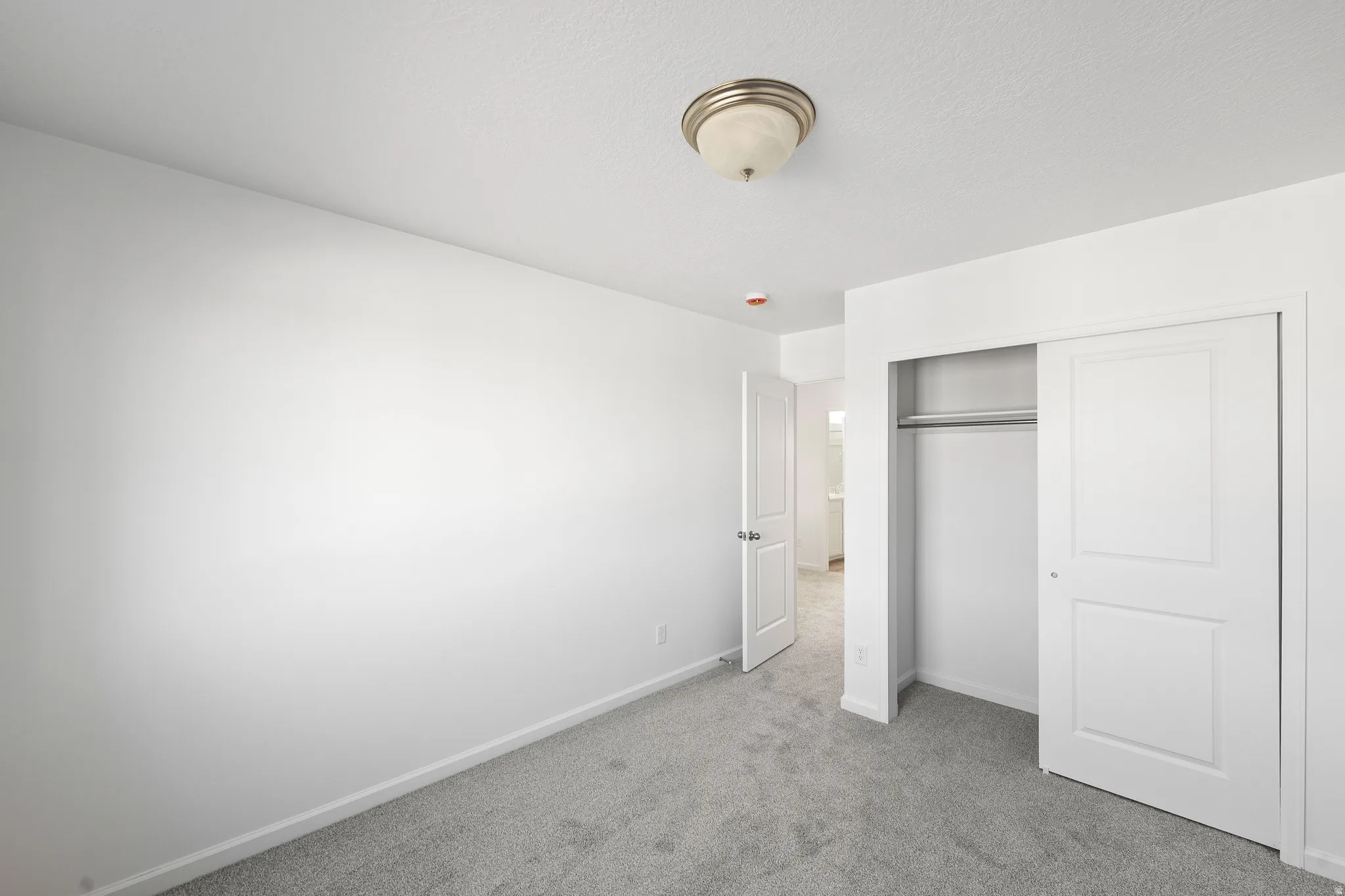 Unfurnished bedroom with carpet flooring and a closet