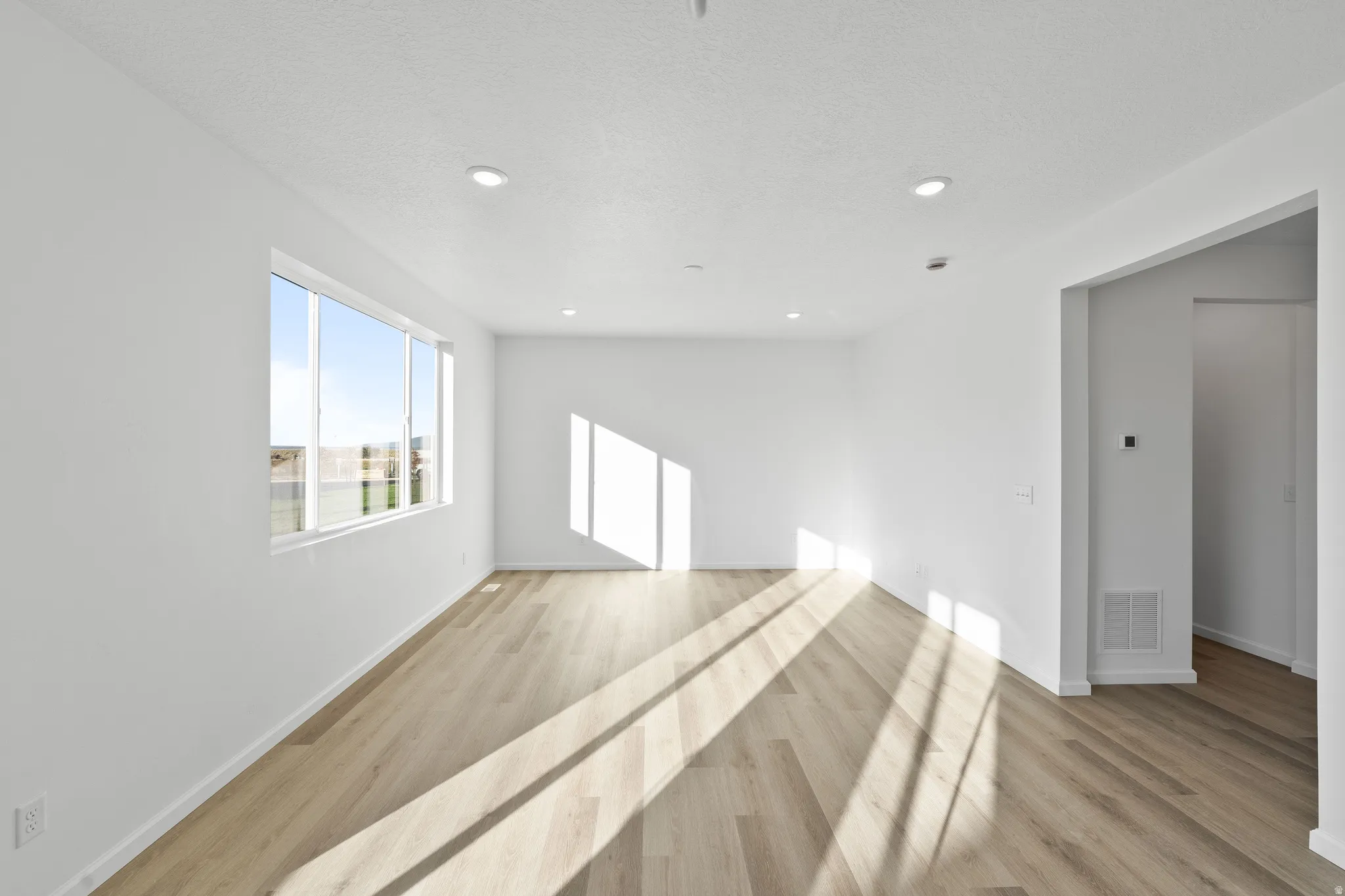 Unfurnished room featuring light wood-style flooring and recessed lighting
