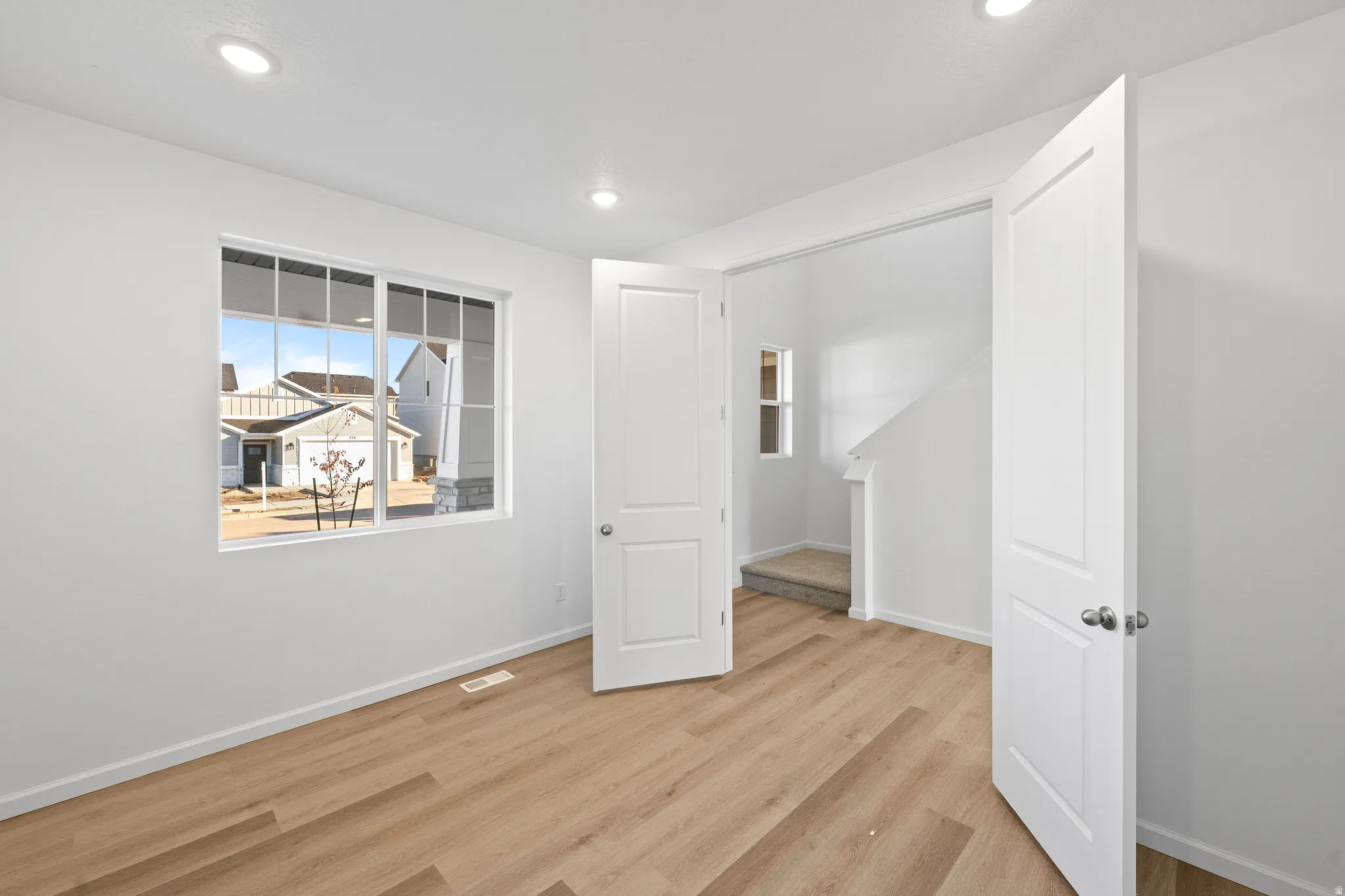 Unfurnished room featuring light wood-type flooring and recessed lighting