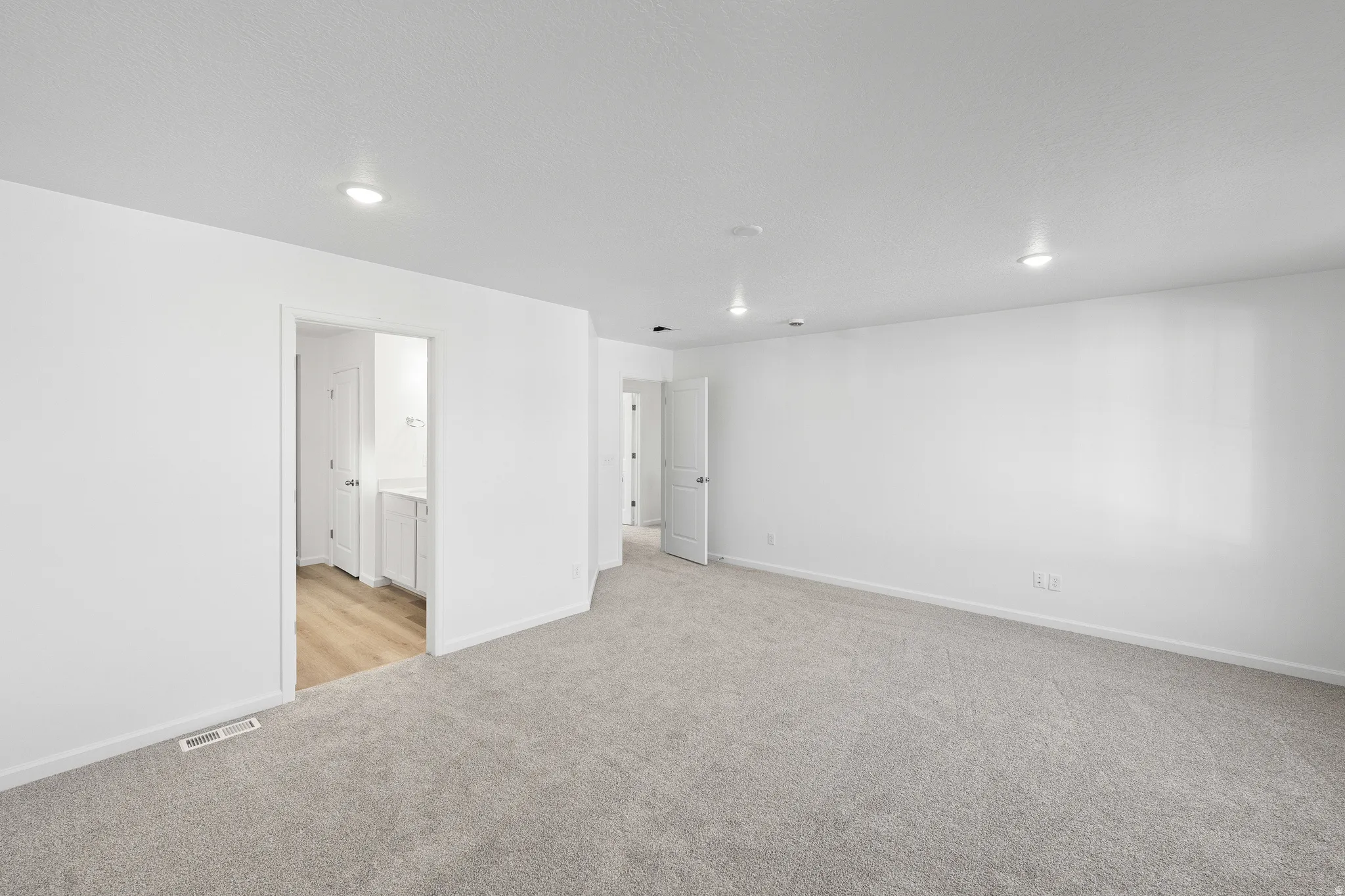 Unfurnished room featuring light colored carpet and recessed lighting