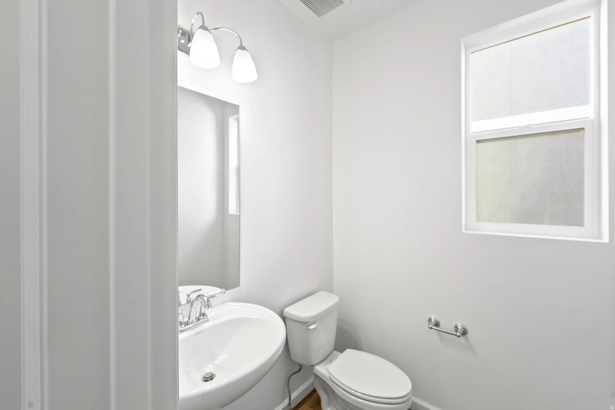 Half bath with a sink and toilet