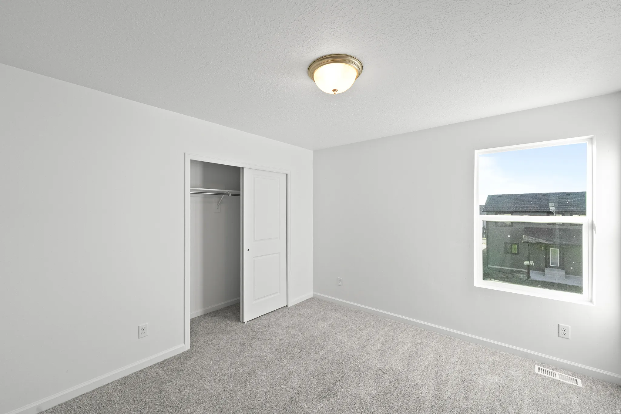 Unfurnished bedroom with carpet flooring and a closet