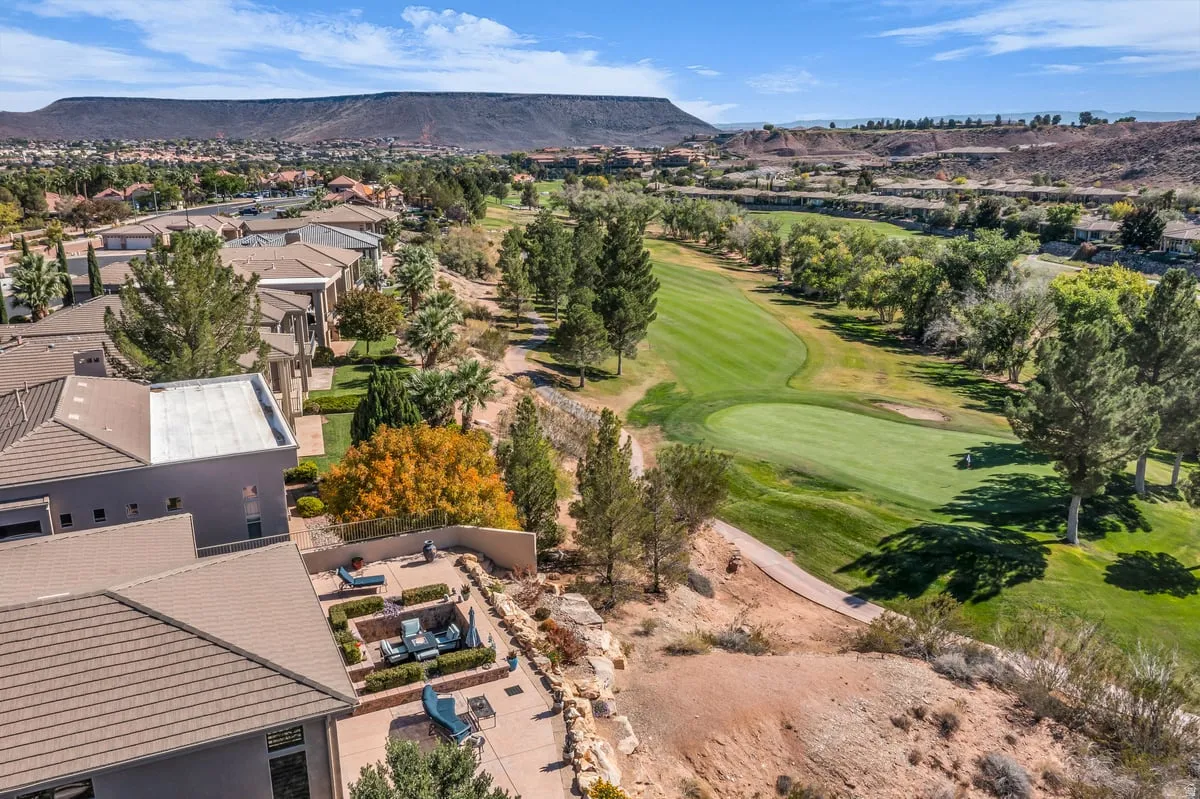 Aerial perspective of suburban area with mountains and a local golf course