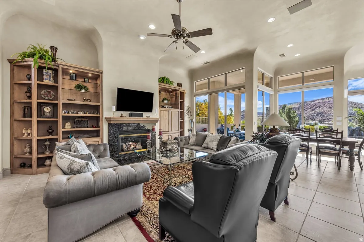 Living area with recessed lighting, light tile patterned floors, a fireplace, and ceiling fan