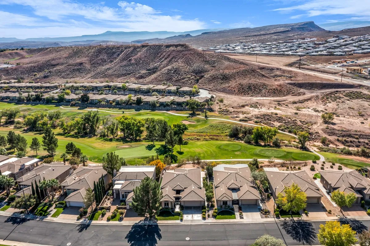Aerial perspective of suburban area featuring mountains and a golf course