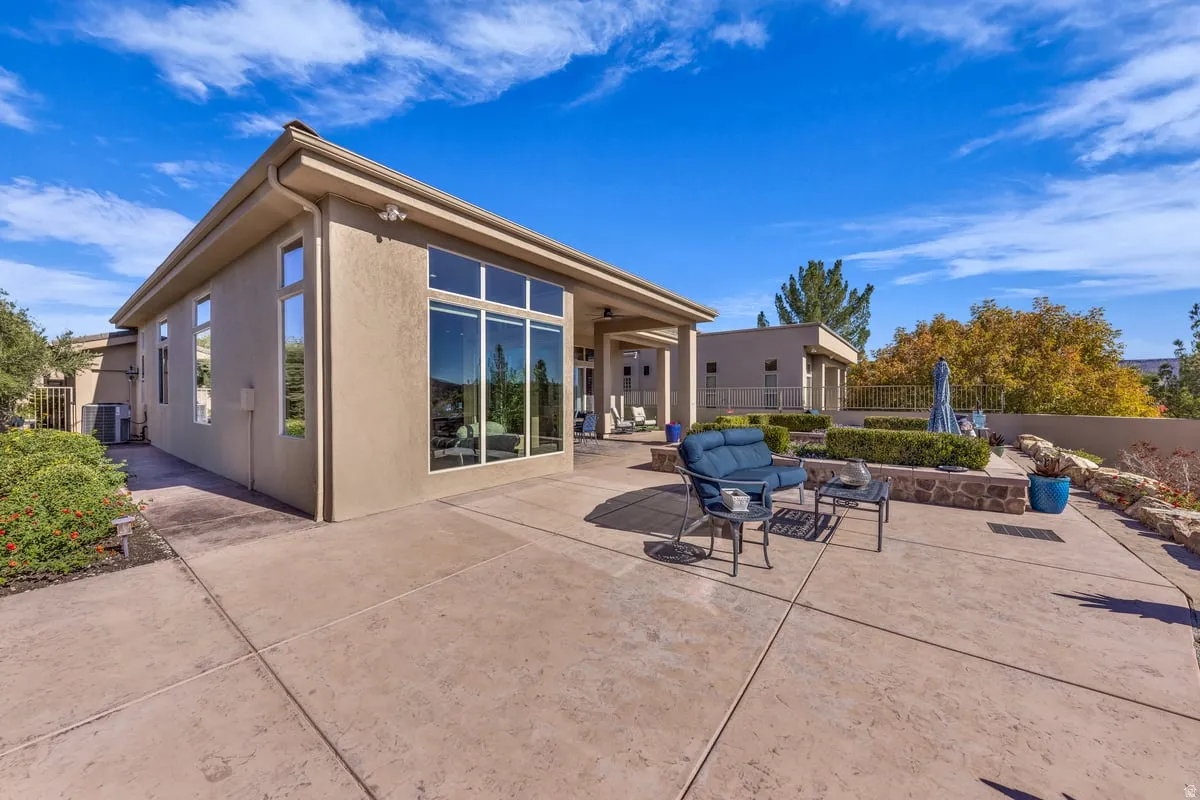 Rear view of property featuring a fenced backyard, stucco siding, and a patio