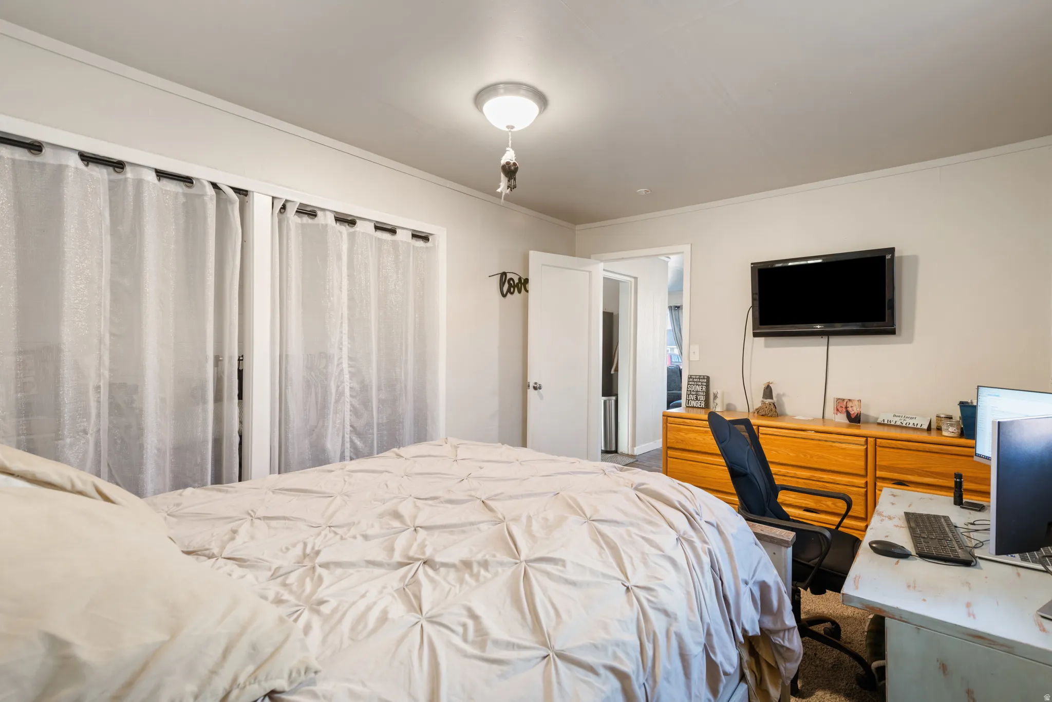 Primary Bedroom featuring a desk and crown molding