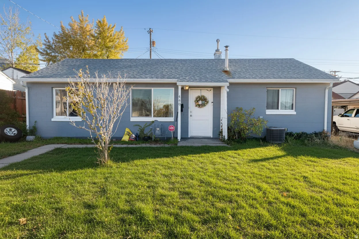 Bungalow-style house with a shingled roof, concrete block siding, and a front yard with AI-staged lawn.