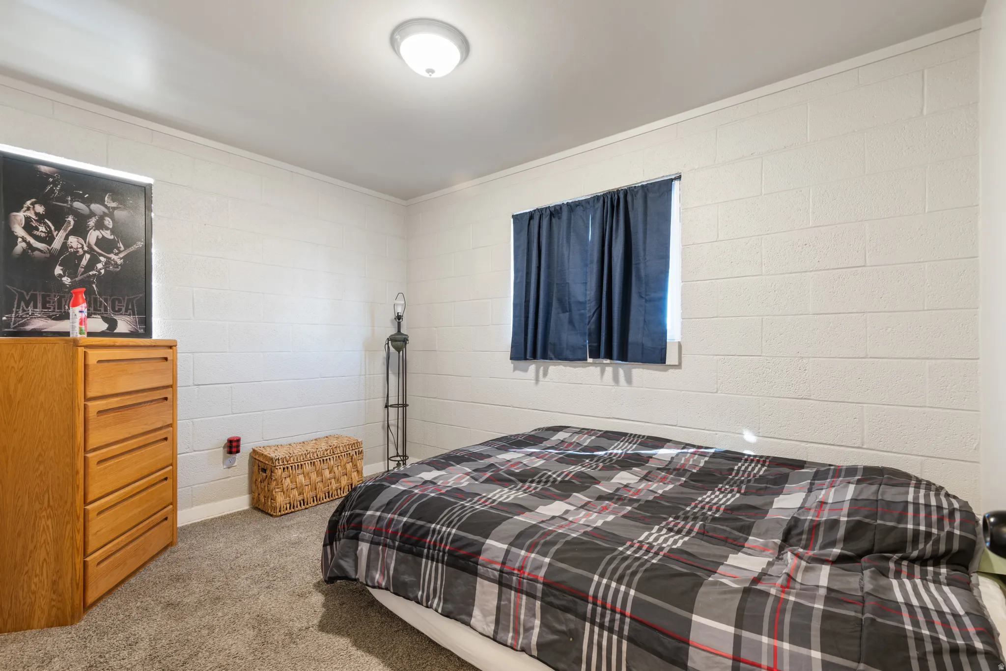 Carpeted bedroom 3 featuring concrete block wall