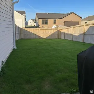 Fenced backyard with a residential view