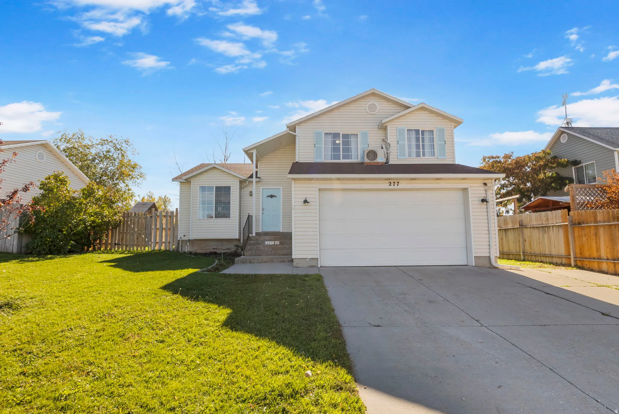 Traditional home featuring concrete driveway and a garage