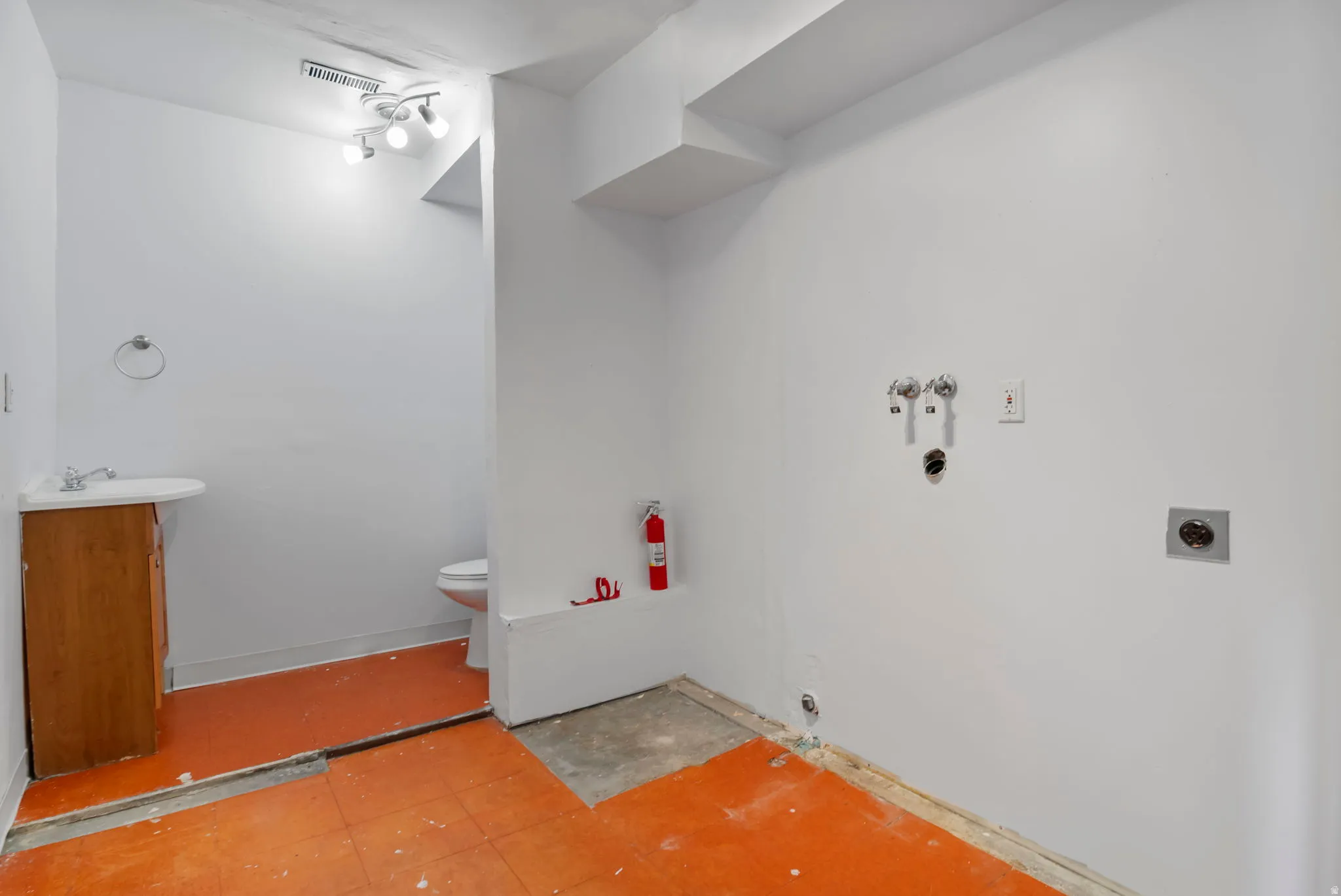 Laundry room / Bathroom with toilet and vanity