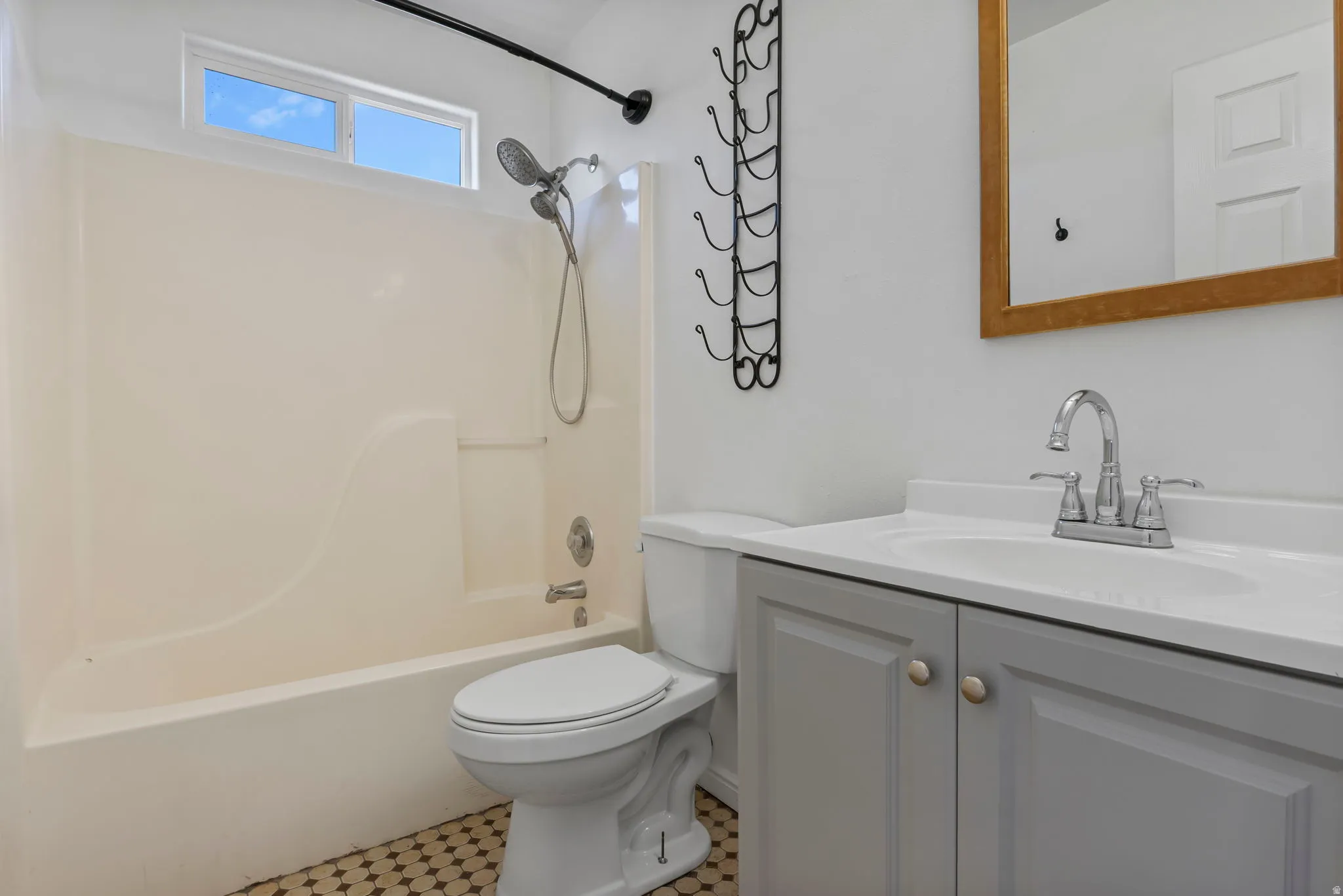 Bathroom featuring vanity and  shower combination