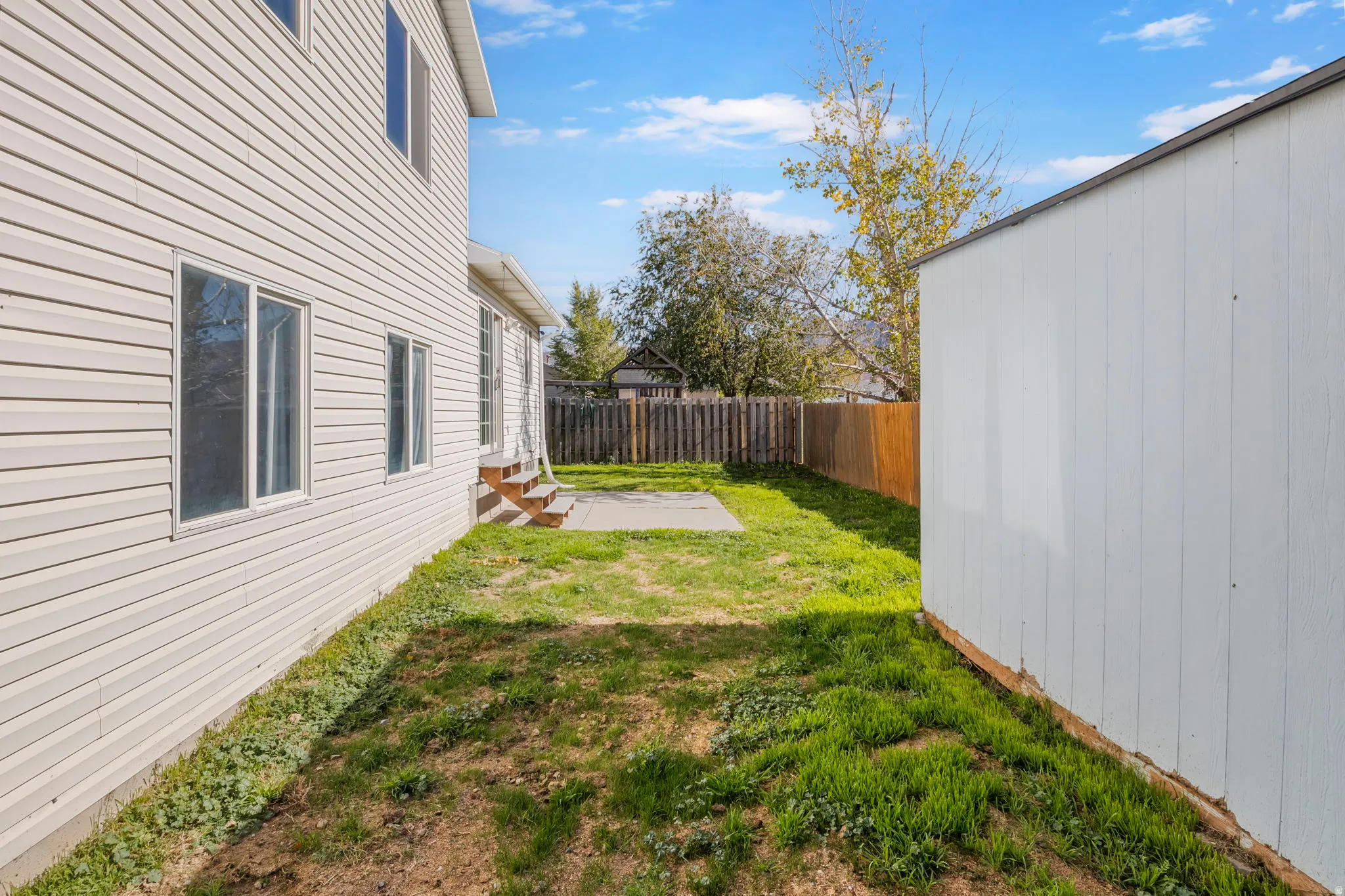 Fenced backyard with a patio