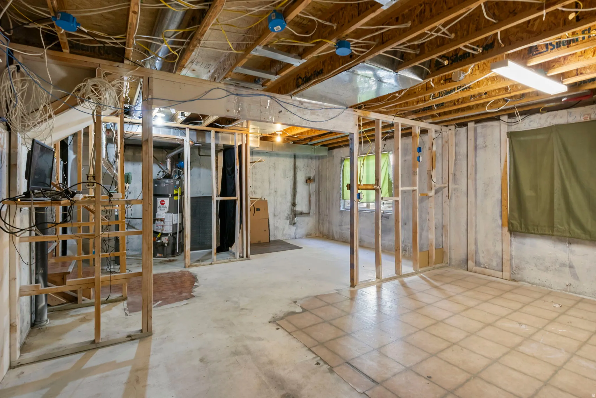 Below grade area featuring water heater