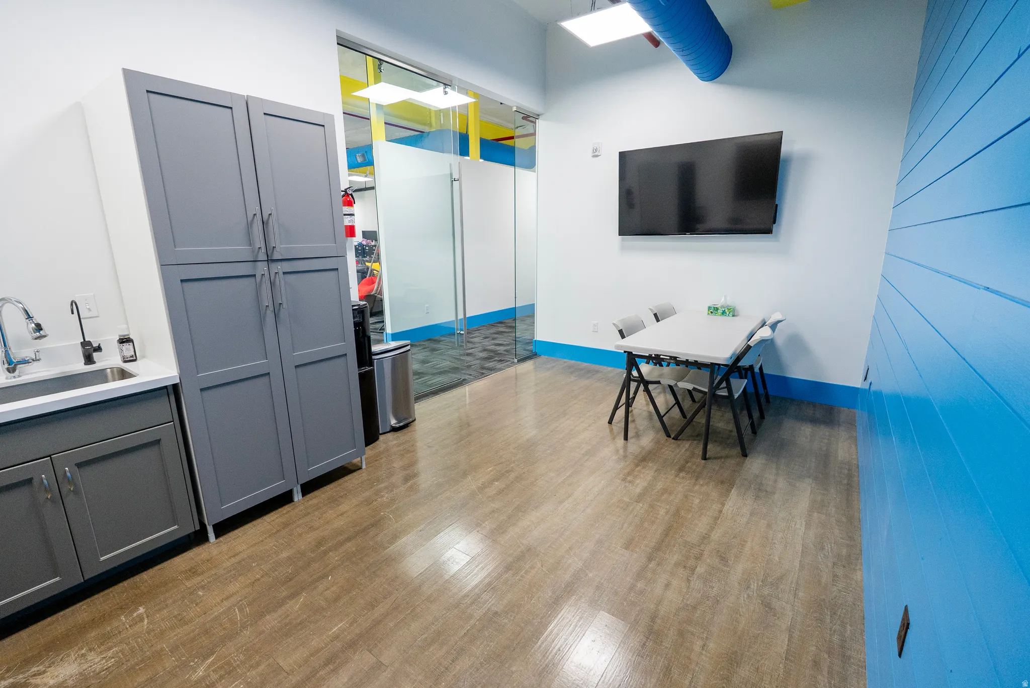 Office area with a sink and light wood-style flooring