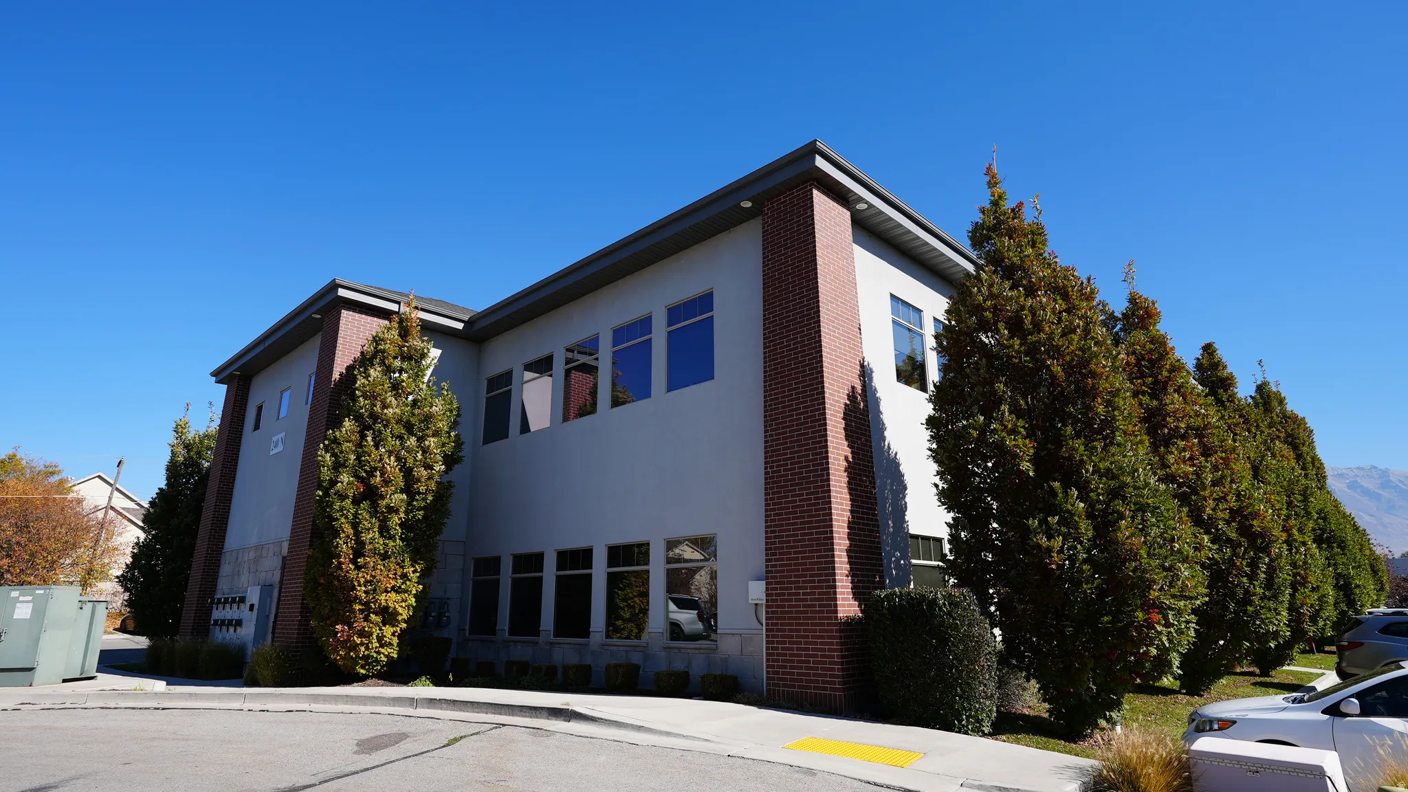 View of property exterior with brick siding and stucco siding