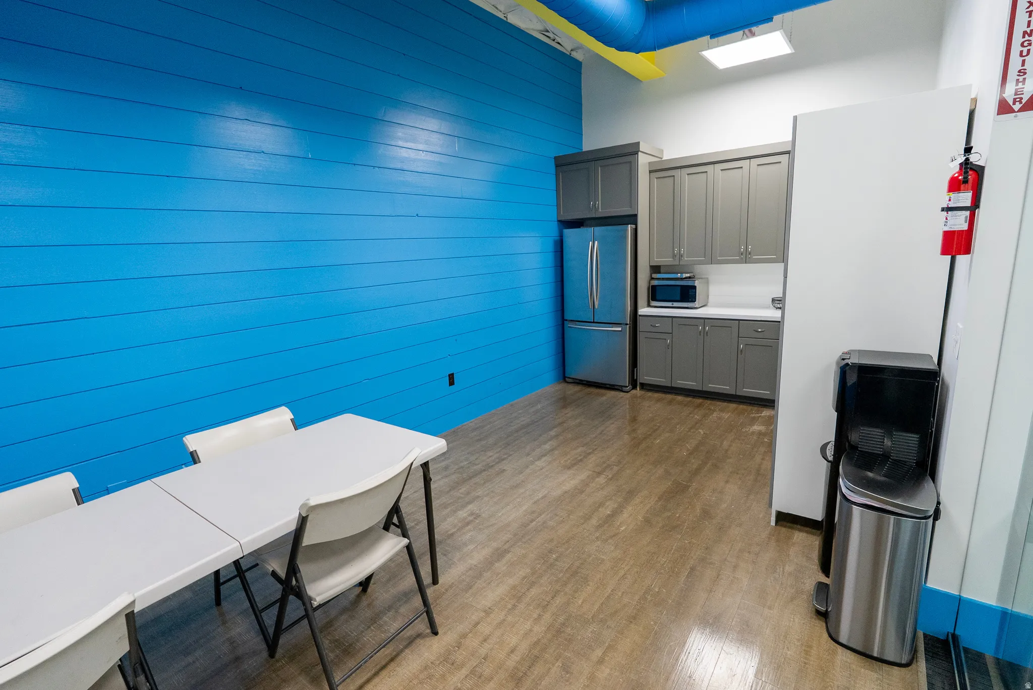 Office with dark wood-style flooring and wooden walls
