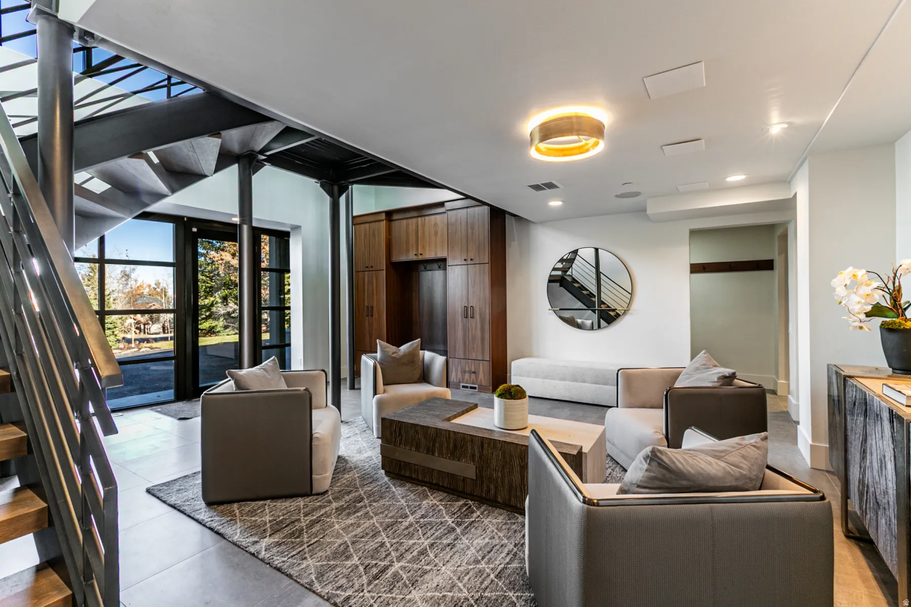 Living room with stairs, light tile patterned flooring, and recessed lighting