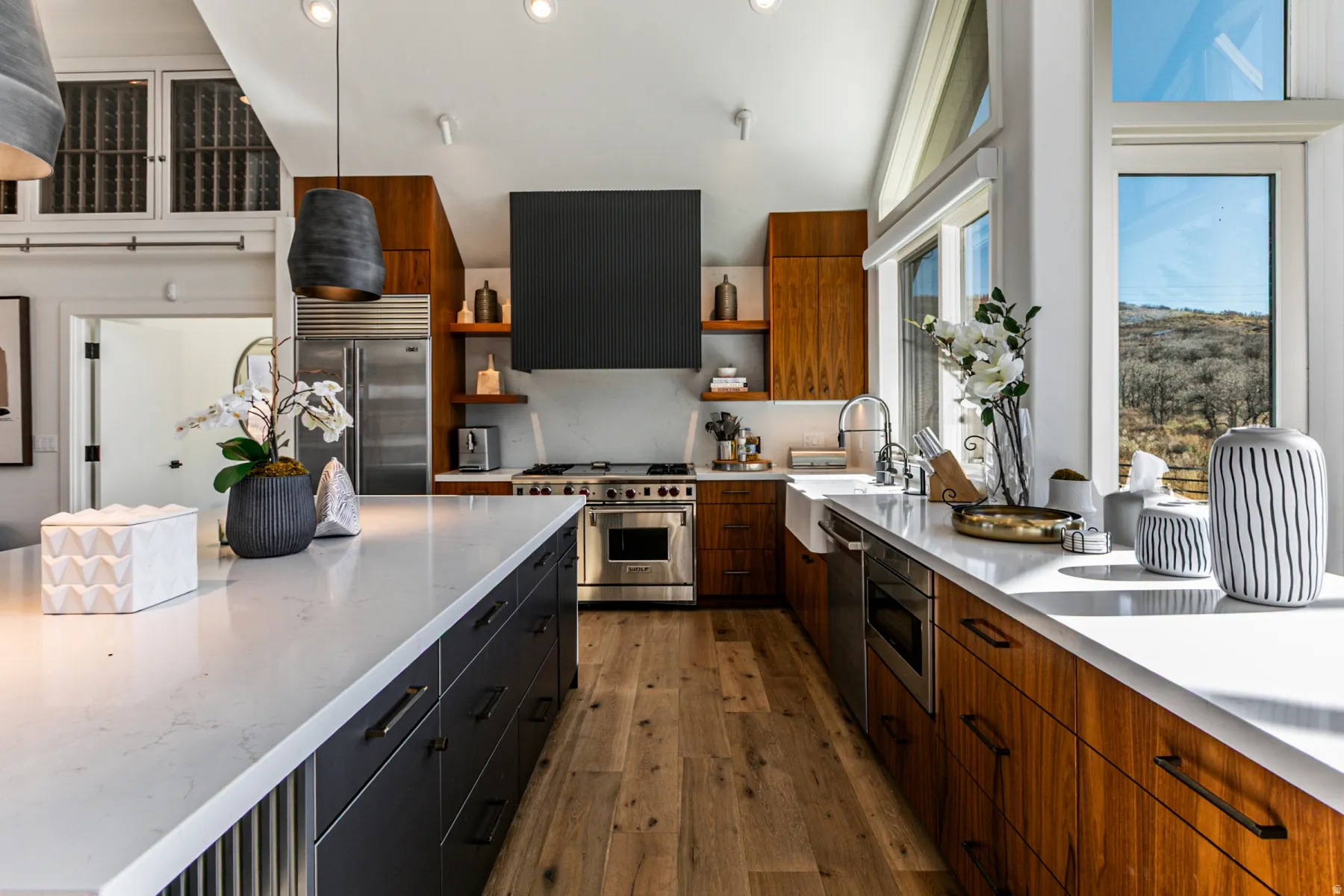 Kitchen with recessed lighting, dark wood-type flooring, built in appliances, light stone counters, and ventilation hood