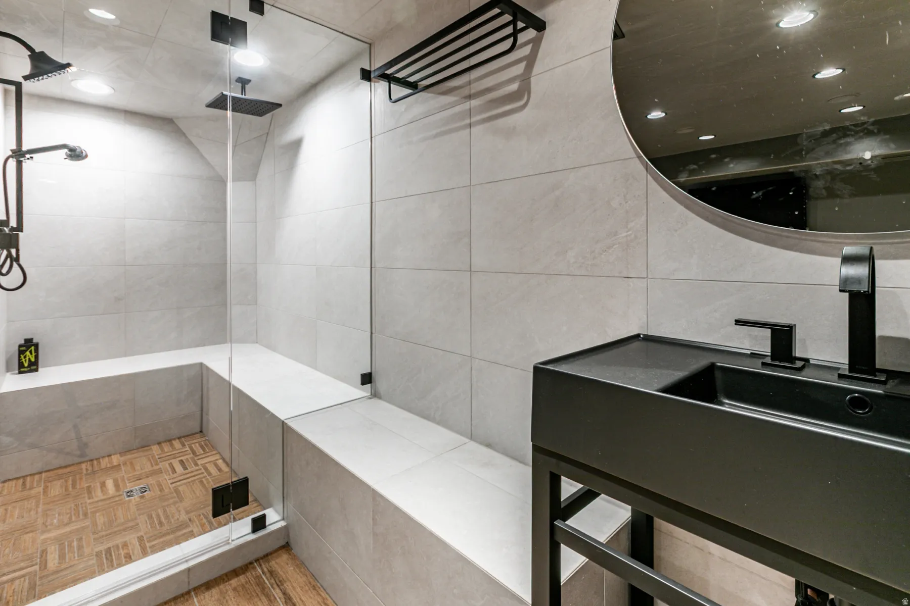 Bathroom with tiled shower, recessed lighting, and tile walls