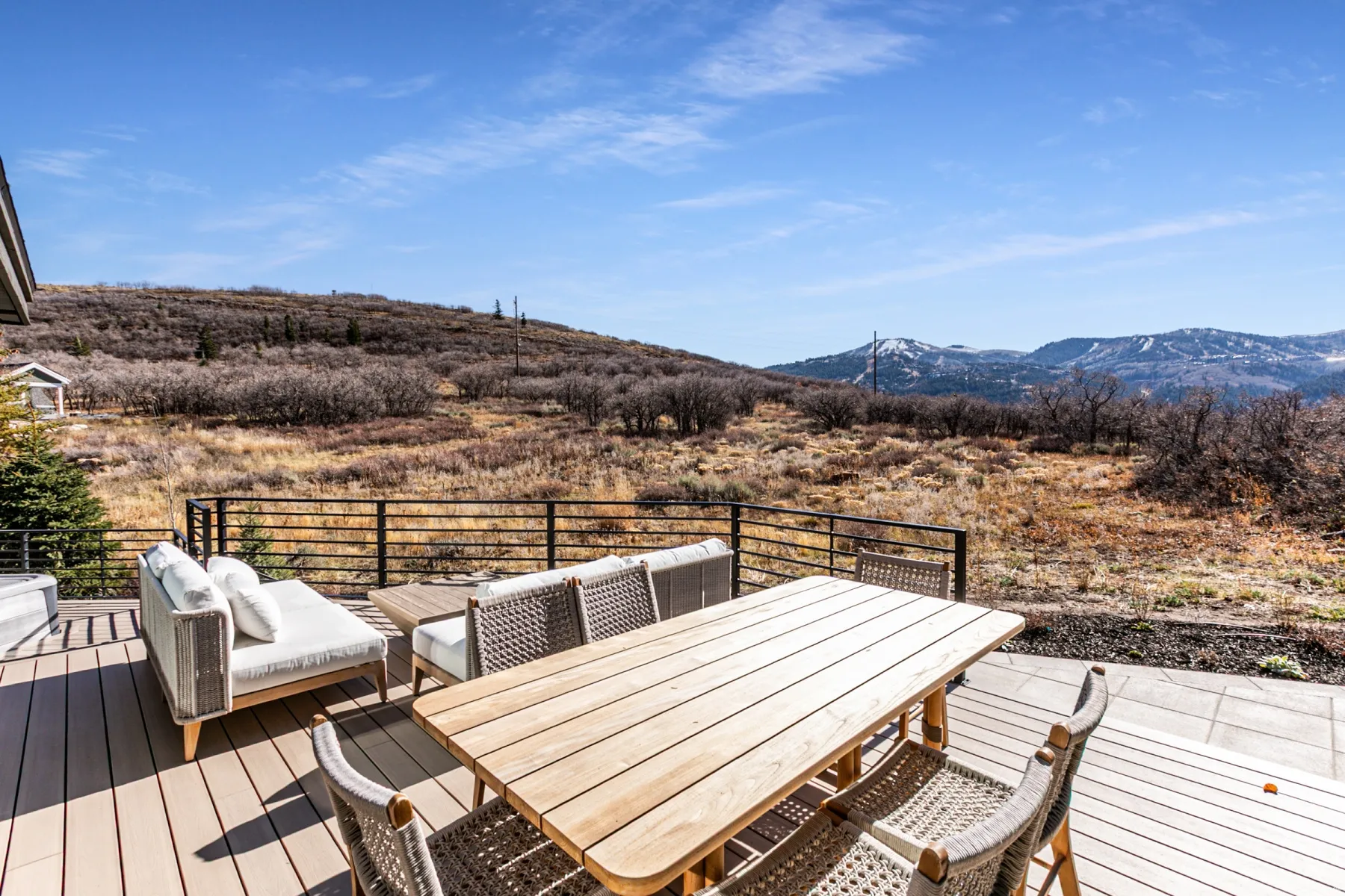 Wooden deck with a mountain view and outdoor dining area