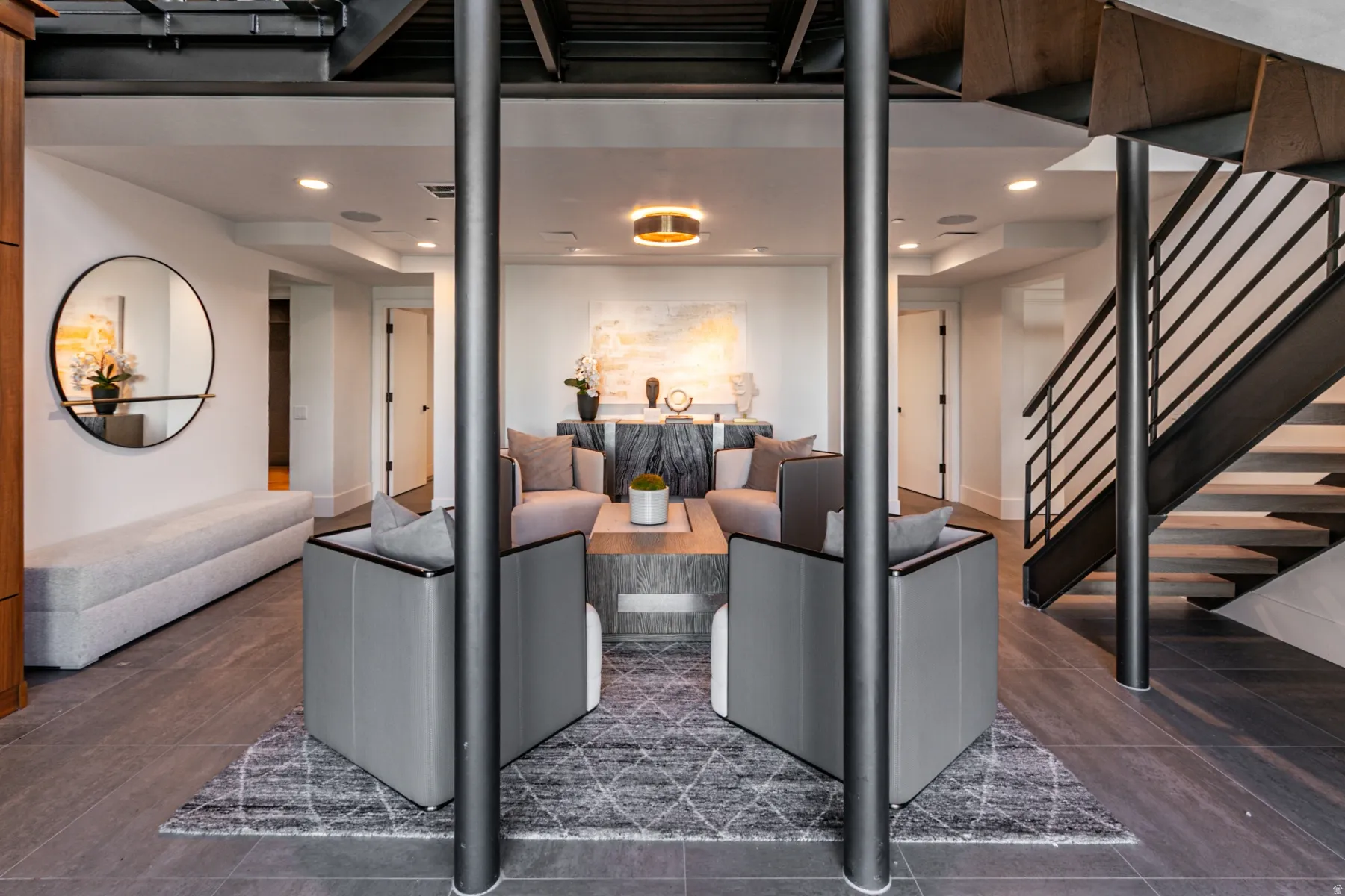 Living room with recessed lighting, stairs, and dark tile patterned flooring