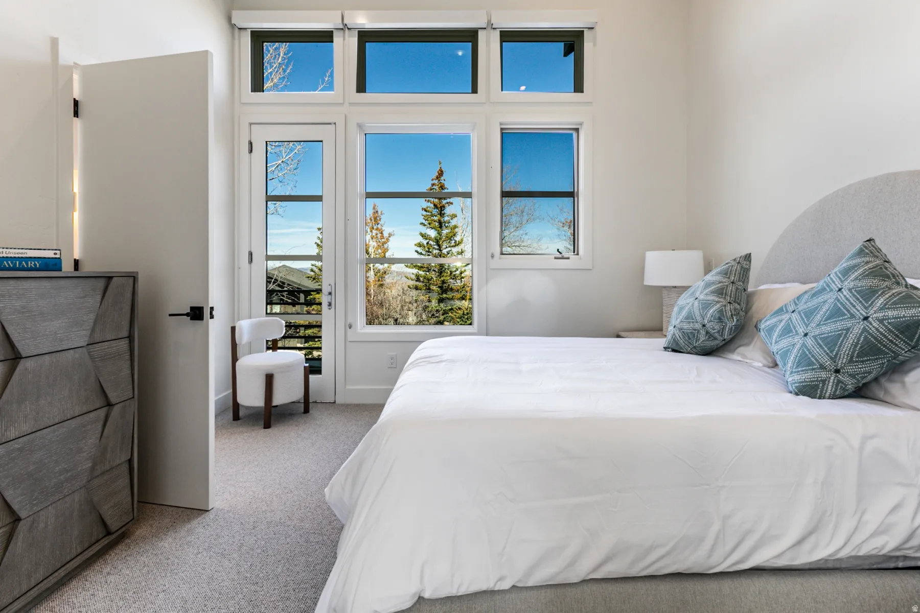 Bedroom with light colored carpet and access to exterior