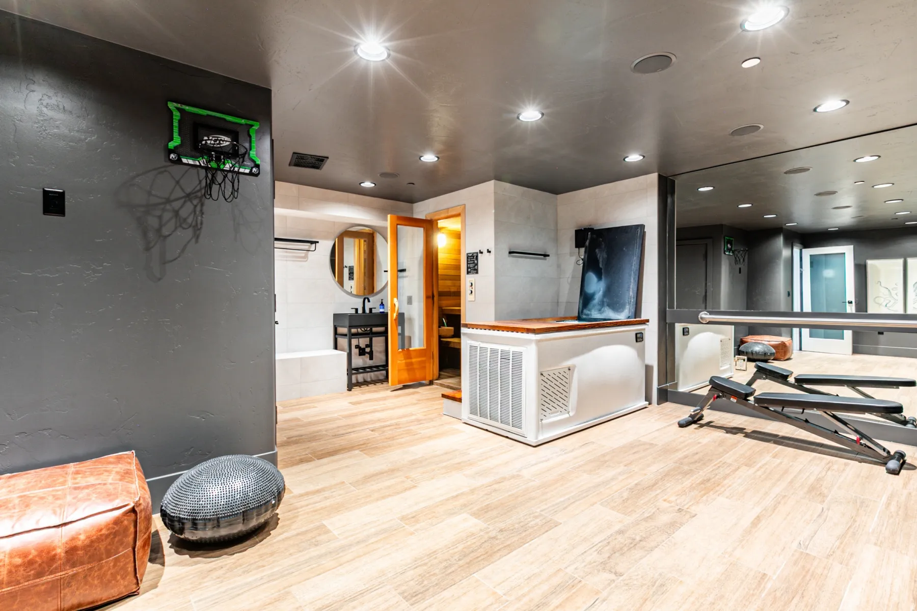 Exercise room with recessed lighting and a textured wall
