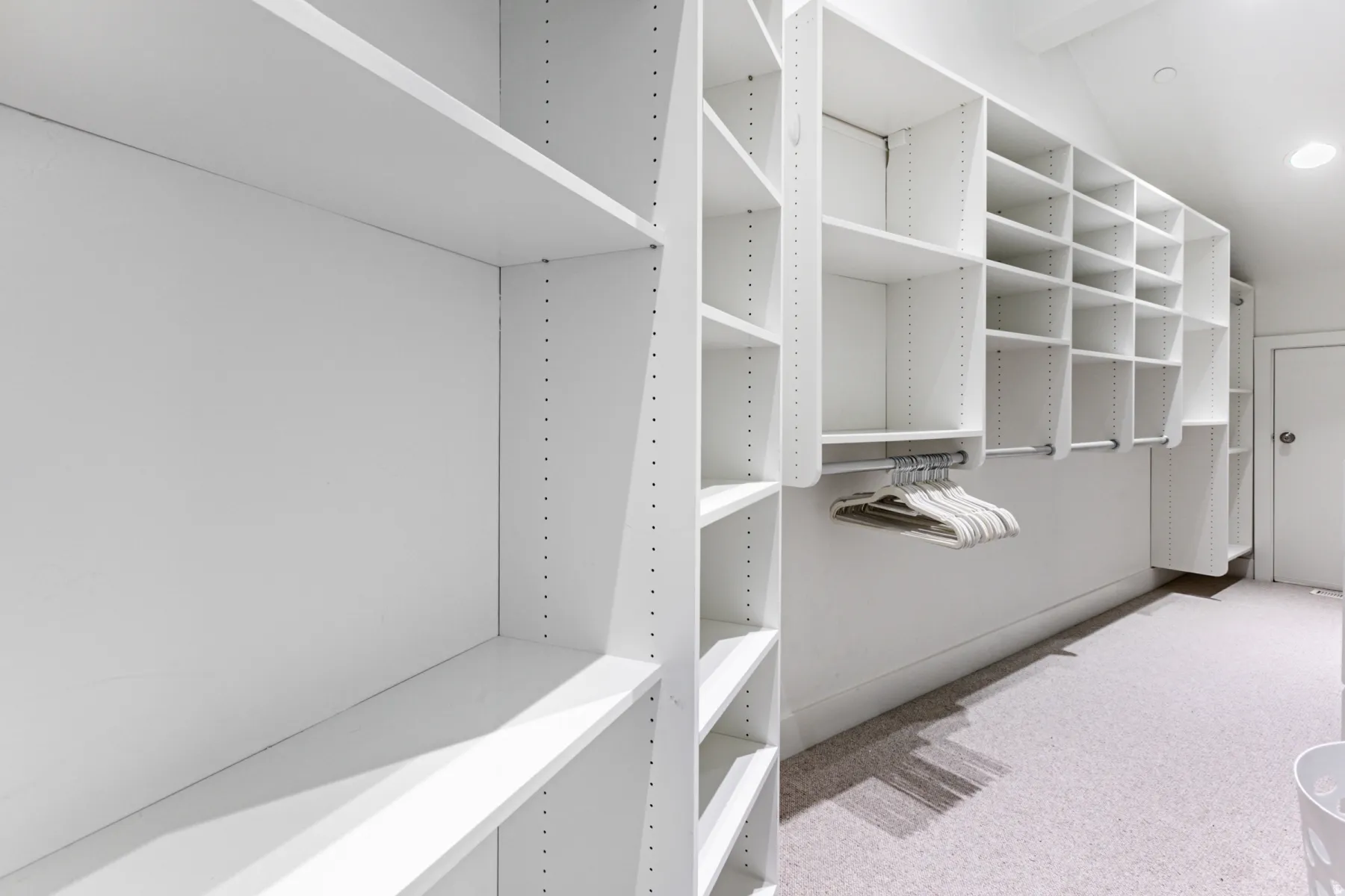Walk in closet with carpet floors