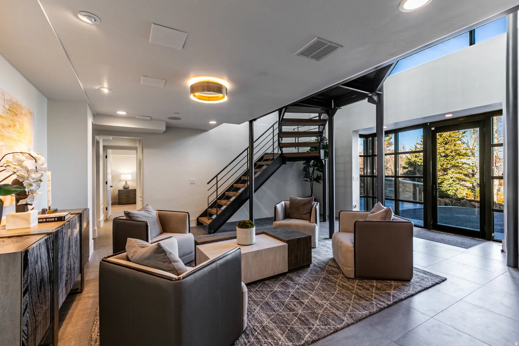 Building lobby featuring stairs, recessed lighting, and floor to ceiling windows