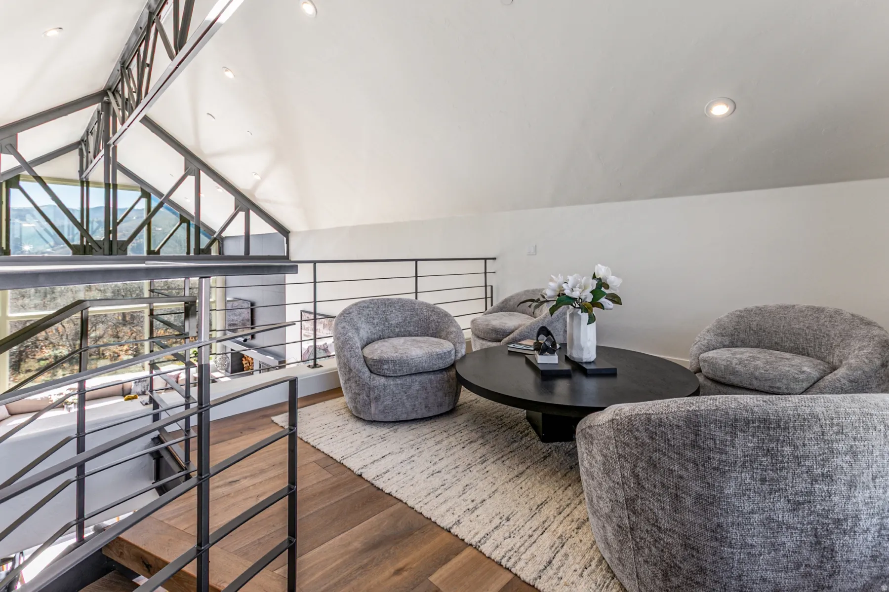 Living area with dark wood finished floors, recessed lighting, and vaulted ceiling