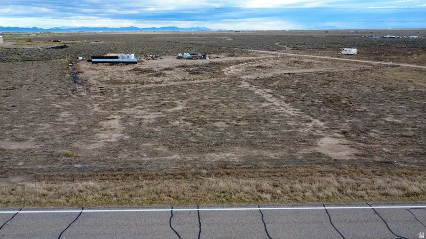 Aerial view of sparsely populated area featuring a mountain backdrop and a desert landscape