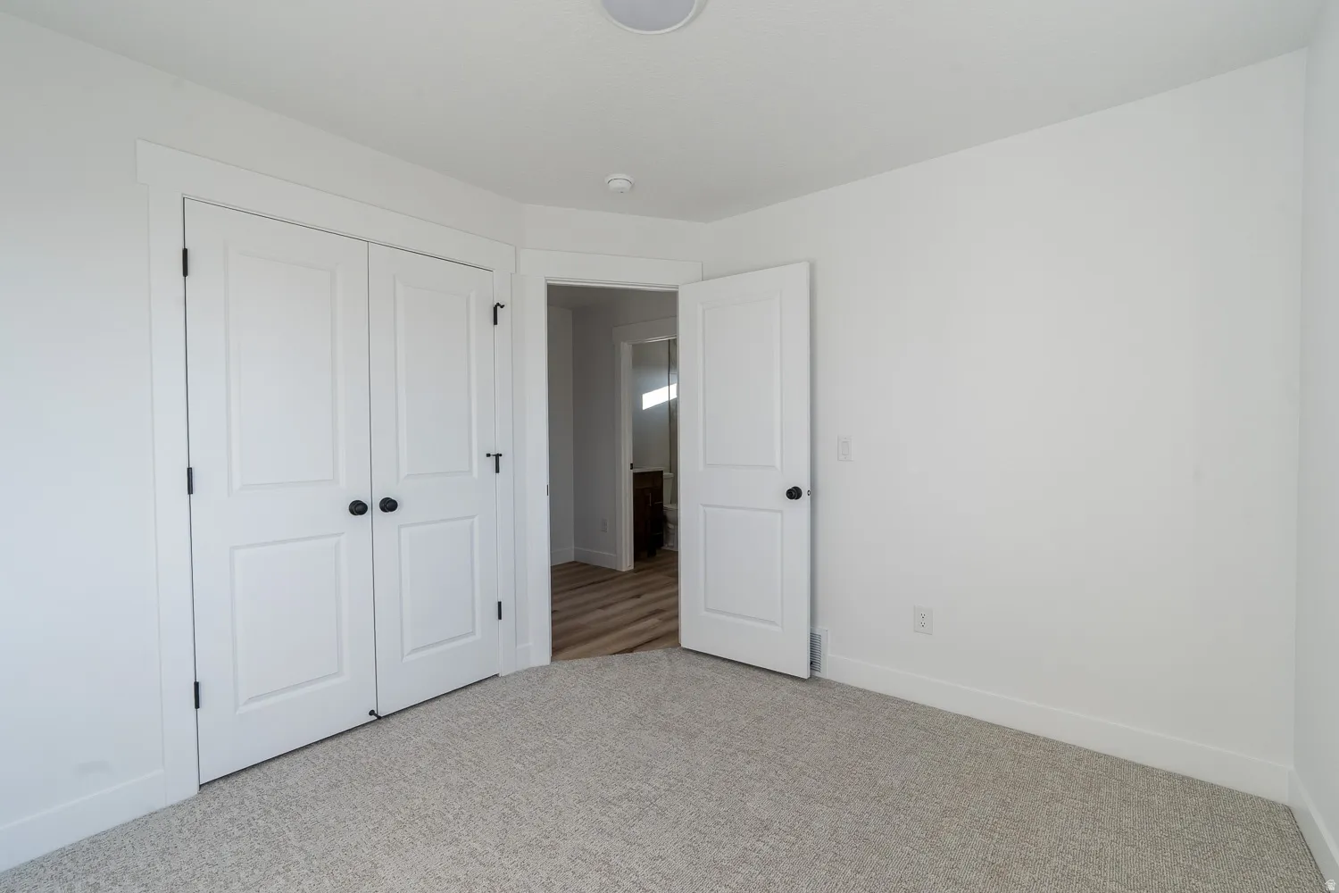 Unfurnished bedroom with carpet and a closet