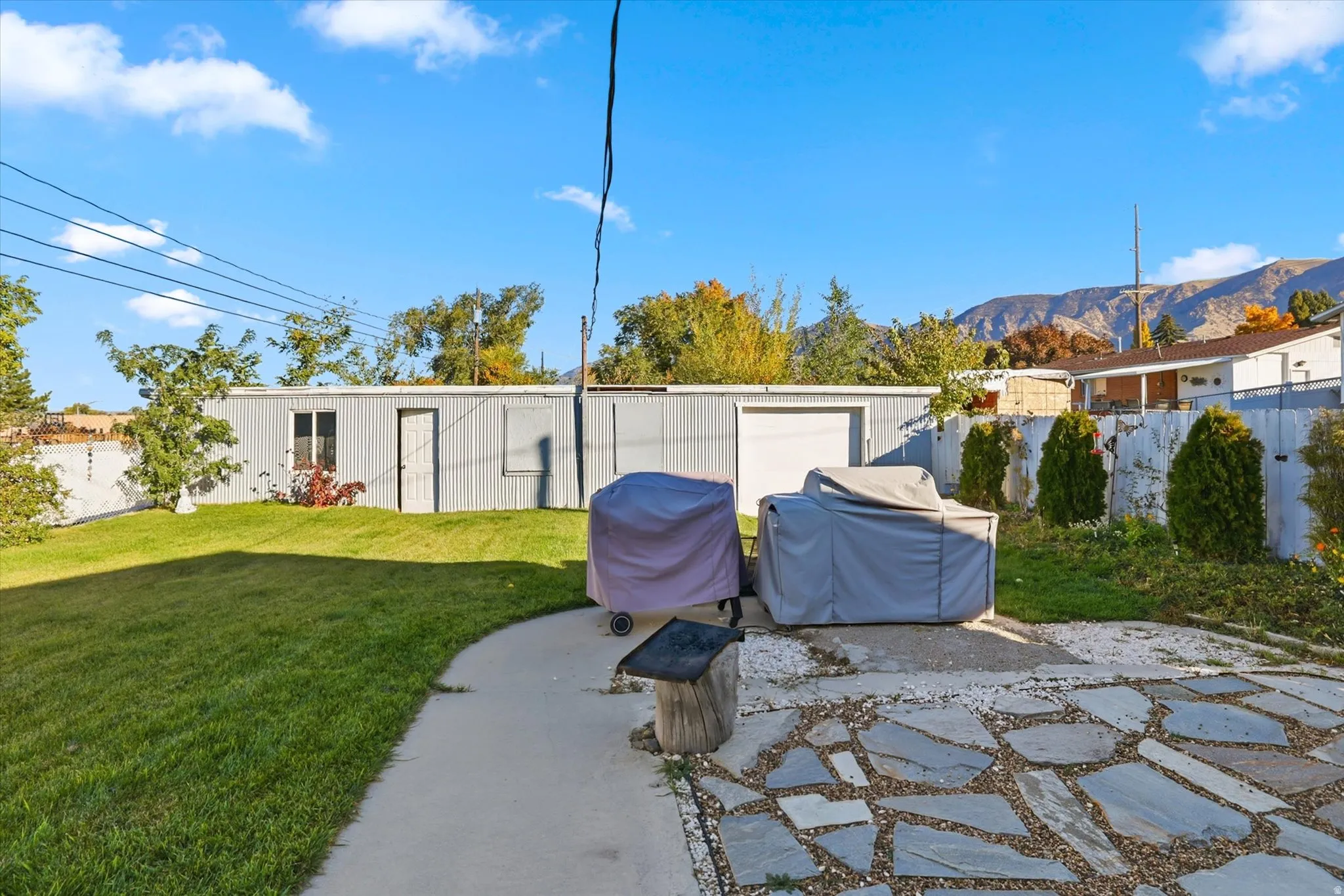 Rear view of house featuring a fenced backyard and a patio area