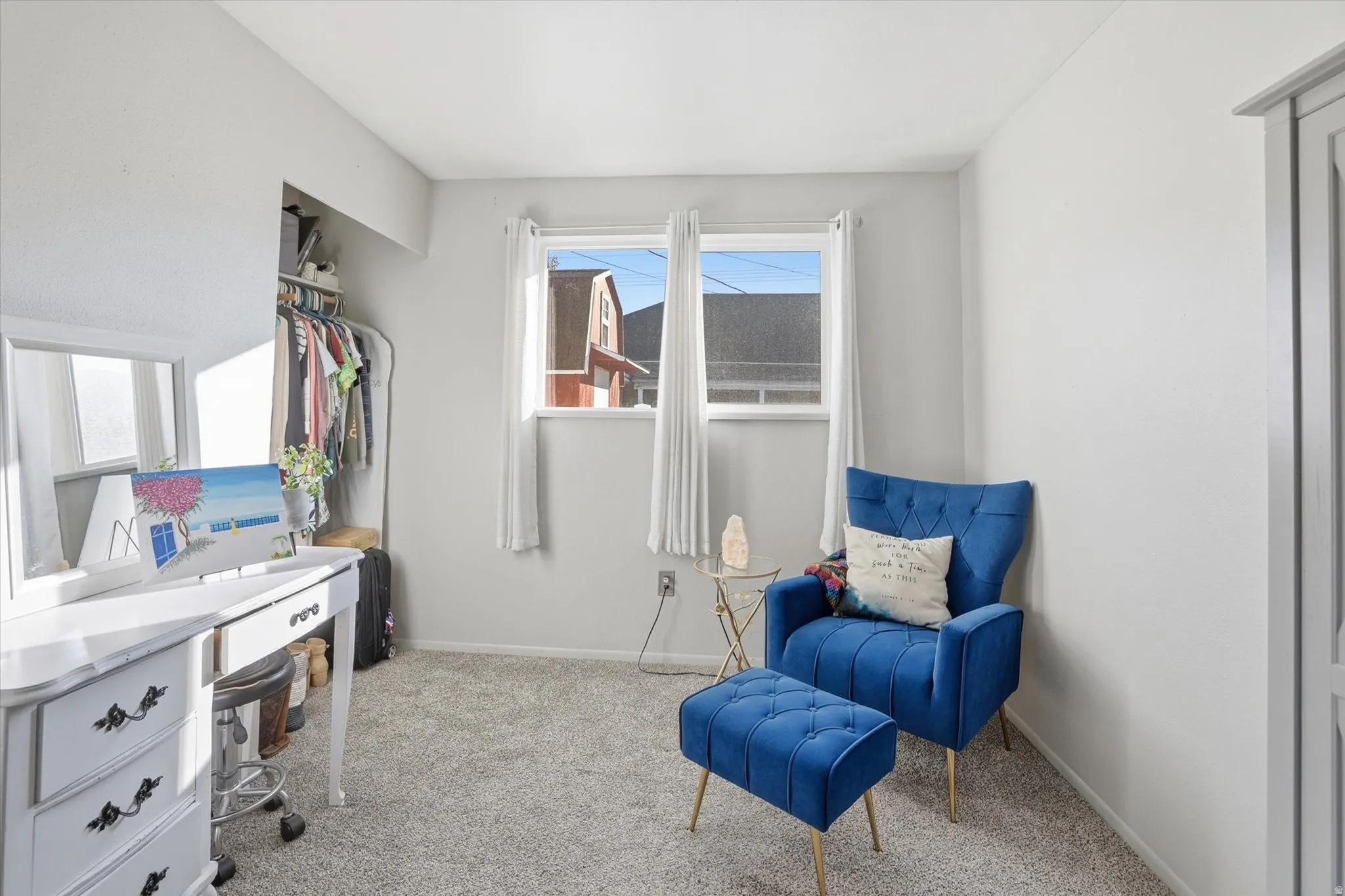 Living area with light carpet and baseboards