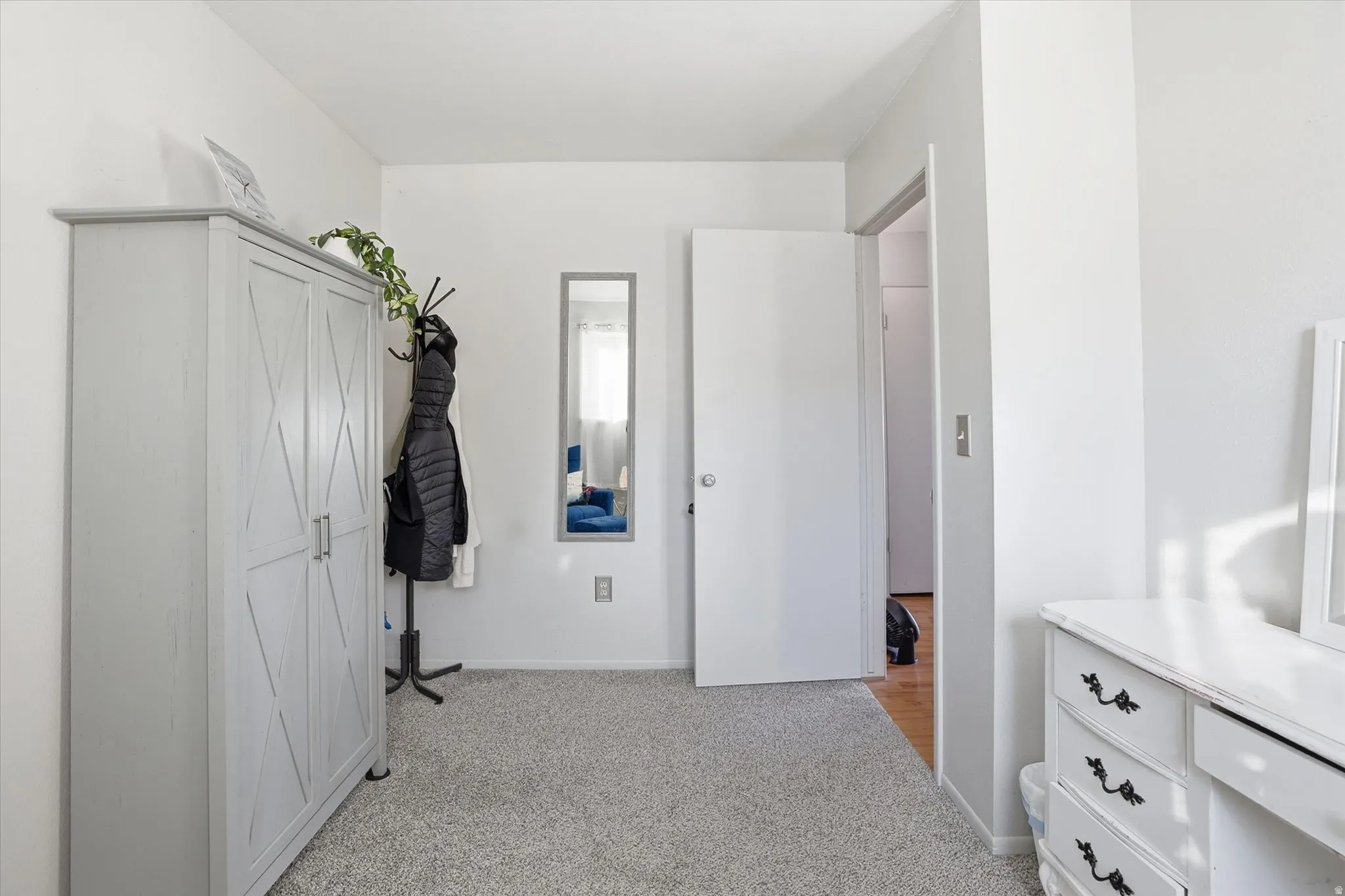 Bedroom with light carpet and baseboards
