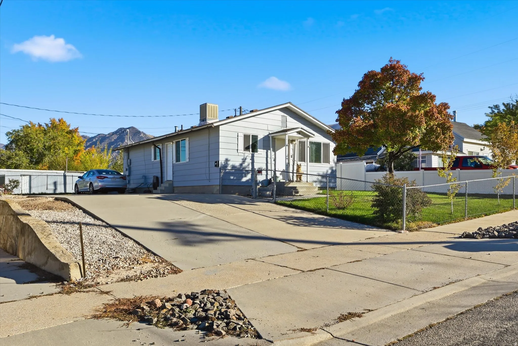 View of front of property with a fenced front yard and concrete driveway