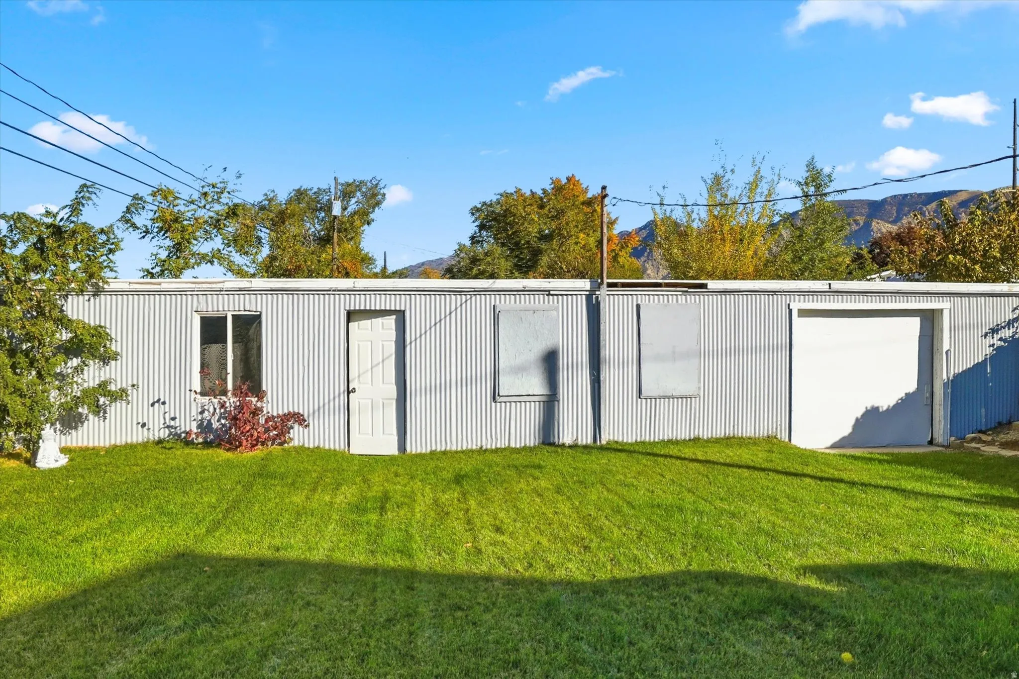 View of outbuilding featuring a mountain view and a garage
