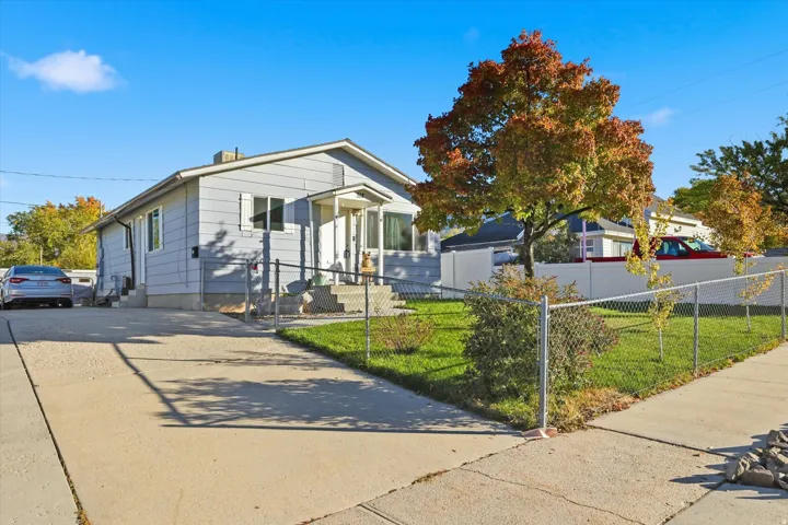Bungalow-style home featuring a fenced front yard