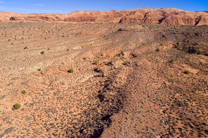 View of mountain backdrop with a desert landscape and rural landscape