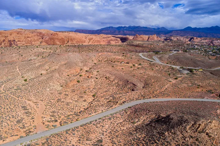 Aerial view of sparsely populated area with a desert landscape and a mountainous background