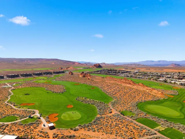 Bird's eye view of a mountain backdrop and a golf course