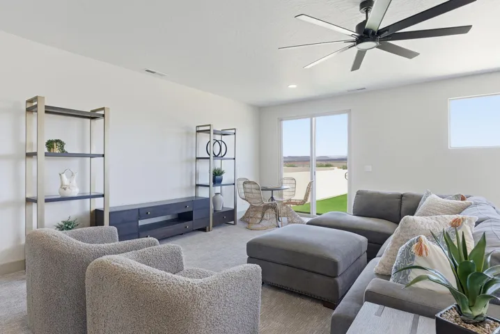 Living area with carpet and a ceiling fan