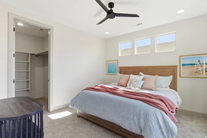 Bedroom with a spacious closet, carpet, a ceiling fan, and recessed lighting