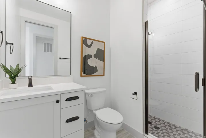 Bathroom featuring vanity and a stall shower
