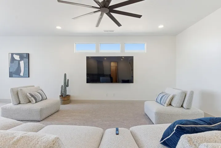 Living room with carpet flooring, recessed lighting, and ceiling fan