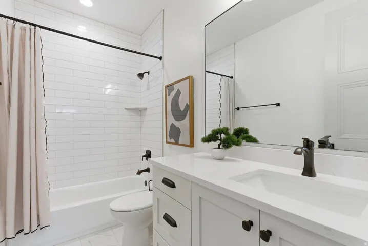 Full bath featuring vanity and shower / tub combo