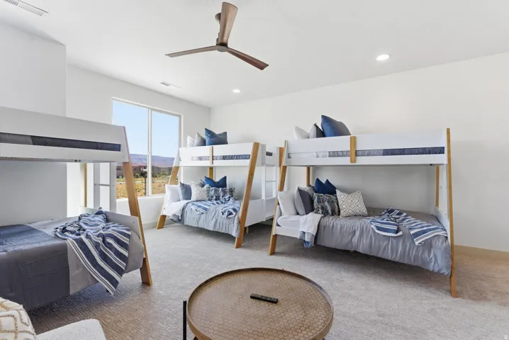 Bedroom with carpet floors, a ceiling fan, a mountain view, and recessed lighting